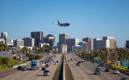 pexels-photo-16307313-16307313 Airplane approaching San Diego airport over busy city freeway and skyline.